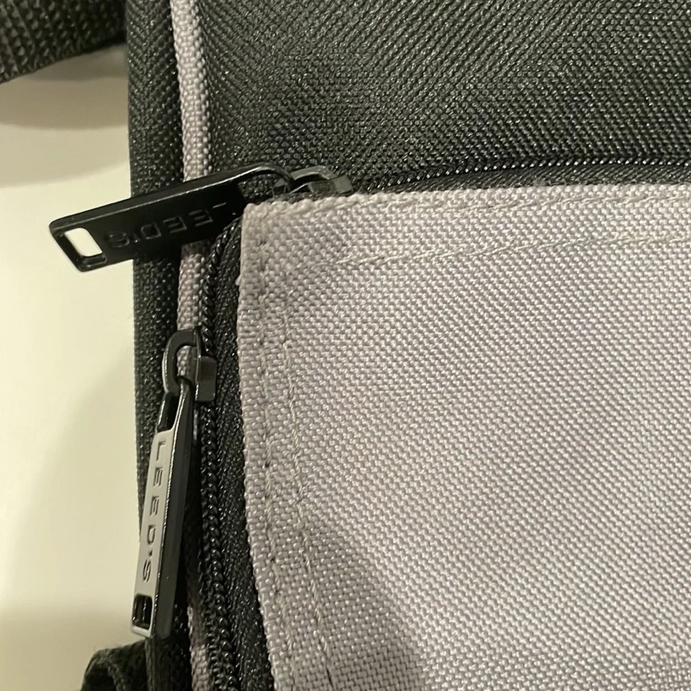 Black and grey canvas messenger bag. NWT
